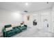 Upstairs bonus room with plush carpeting and a cozy green sofa at 1563 Old Rivers Rd, Concord, NC 28027