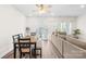 Sunlit dining area with modern table, bench seating, and doors to the backyard at 1563 Old Rivers Rd, Concord, NC 28027