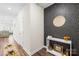 Hallway featuring wood floors, stylish wallpaper, and a decorative table at 1563 Old Rivers Rd, Concord, NC 28027