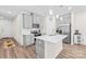 Modern kitchen with gray cabinets, stainless appliances, and center island at 1563 Old Rivers Rd, Concord, NC 28027