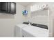 Laundry room with side by side washer and dryer and overhead storage at 1563 Old Rivers Rd, Concord, NC 28027