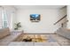 Cozy living room features a wall-mounted TV, comfortable seating, and neutral decor at 1563 Old Rivers Rd, Concord, NC 28027