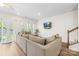 Cozy living room with sectional sofa, tv, and sliding glass doors at 1563 Old Rivers Rd, Concord, NC 28027