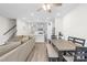 Bright open-plan living and dining area with modern gray kitchen and wood-look flooring at 1563 Old Rivers Rd, Concord, NC 28027