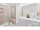 Main bathroom with double sinks, modern vanity, and tiled walk-in shower at 1563 Old Rivers Rd, Concord, NC 28027
