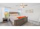 Spacious main bedroom with a ceiling fan, windows, and a cozy bed at 1563 Old Rivers Rd, Concord, NC 28027