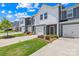 Attractive townhomes with garages, green lawns and manicured landscaping at 1563 Old Rivers Rd, Concord, NC 28027