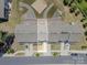 Aerial view showing the layout of attached townhomes with well-kept yards and parking at 16039 Simril Ct, Charlotte, NC 28278