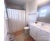 Standard bathroom featuring a shower with white curtain and a single sink vanity at 16039 Simril Ct, Charlotte, NC 28278