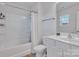Bright bathroom with a shower-tub combo and modern white fixtures at 16039 Simril Ct, Charlotte, NC 28278