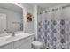 White bathroom with a shower featuring a blue patterned shower curtain at 16039 Simril Ct, Charlotte, NC 28278
