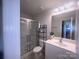 Well-lit bathroom with glass-enclosed shower, modern vanity, and ample storage space at 16039 Simril Ct, Charlotte, NC 28278