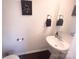 Charming powder room with pedestal sink and stylish decor offers a convenient space for guests at 16039 Simril Ct, Charlotte, NC 28278