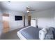 Bright bedroom features a ceiling fan and a wall-mounted television at 16039 Simril Ct, Charlotte, NC 28278