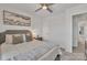 Bright bedroom with ceiling fan, soft gray carpet, and doorway to the hallway at 16039 Simril Ct, Charlotte, NC 28278