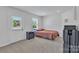 Minimalist bedroom with a bed, window, door, and dresser at 16039 Simril Ct, Charlotte, NC 28278