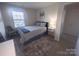 Inviting bedroom with a large window and neutral color scheme provides a relaxing atmosphere at 16039 Simril Ct, Charlotte, NC 28278