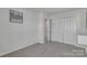 Clean, carpeted bedroom with a double door closet and a doorway to the hallway at 16039 Simril Ct, Charlotte, NC 28278