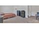 Simple bedroom with bed, dresser, and carpeted floors at 16039 Simril Ct, Charlotte, NC 28278