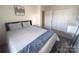 Bright bedroom featuring large windows, ceiling fan and spacious closet at 16039 Simril Ct, Charlotte, NC 28278