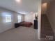 Spacious bonus room features a bed and a door to the exterior at 16039 Simril Ct, Charlotte, NC 28278