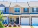 Charming townhome with a stone accent, attached garage, and cozy front porch seating area at 16039 Simril Ct, Charlotte, NC 28278