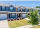 Street view of townhomes featuring manicured lawns, colorful exteriors, and attached garages at 16039 Simril Ct, Charlotte, NC 28278
