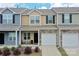 Charming townhome showcasing a one-car garage and a cozy front porch, with diverse exterior colors and stone accents at 16039 Simril Ct, Charlotte, NC 28278