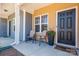 Cozy front porch featuring neutral seating and a black front door with a flower display at 16039 Simril Ct, Charlotte, NC 28278