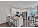 Well-lit kitchen with stainless steel appliances, granite countertops, and a breakfast bar at 16039 Simril Ct, Charlotte, NC 28278