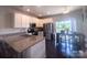 Bright kitchen featuring granite countertops, stainless steel appliances, and a dining area with a backyard view at 16039 Simril Ct, Charlotte, NC 28278