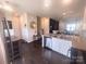 Open-concept kitchen with granite countertops, stainless steel appliances, and seamless flow to the living area at 16039 Simril Ct, Charlotte, NC 28278