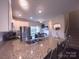 Modern kitchen with granite countertops, stainless steel appliances, and a breakfast bar, perfect for casual dining at 16039 Simril Ct, Charlotte, NC 28278