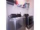 Efficient laundry area with modern washer and dryer, plus shelving for storage and supplies at 16039 Simril Ct, Charlotte, NC 28278