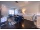 Inviting living room with neutral tones, an elegant sofa, chic lighting, and seamless flow to the kitchen area at 16039 Simril Ct, Charlotte, NC 28278