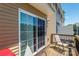 Private outdoor patio with sliding glass door and wood railing at 16039 Simril Ct, Charlotte, NC 28278