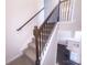 Elegant staircase with dark wood railing and iron spindles leading to the upper level at 16039 Simril Ct, Charlotte, NC 28278