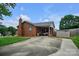 Backyard view of brick home featuring a patio area and shed for storage at 1609 Mcfarland Dr, Shelby, NC 28152