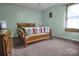 Comfortable bedroom with natural light, featuring a well-made bed and neutral decor at 1609 Mcfarland Dr, Shelby, NC 28152