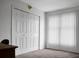 Neutral bedroom with carpet flooring, double closets, and a large sunny window at 1609 Mcfarland Dr, Shelby, NC 28152