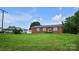 This home is surrounded by a lush lawn with mature trees and features a classic brick exterior at 1609 Mcfarland Dr, Shelby, NC 28152