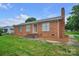 Charming brick home featuring a well-maintained lawn, mature trees, and a welcoming entrance at 1609 Mcfarland Dr, Shelby, NC 28152