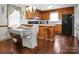 Eat-in kitchen features matching appliances, wood cabinets, and breakfast bar at 1609 Mcfarland Dr, Shelby, NC 28152