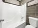 A bathroom is shown with a tiled wall and bathtub at 1908 Harvest Ln # 5, Charlotte, NC 28210