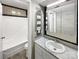 Nicely decorated bathroom featuring decorative tiles, a vanity with a sink, and a bathtub at 1908 Harvest Ln # 5, Charlotte, NC 28210