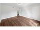 Clean bedroom with hardwood floors, white trim, and closet at 1908 Harvest Ln # 5, Charlotte, NC 28210