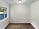 A bright bedroom is shown with wood-look floors and a window to the outside at 1908 Harvest Ln # 5, Charlotte, NC 28210