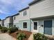 An exterior elevation is shown of a 2-story townhome with a blue front door and landscaping at 1908 Harvest Ln # 5, Charlotte, NC 28210