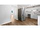 A kitchen is shown with white cabinets, stainless appliances, and wood-look floors at 1908 Harvest Ln # 5, Charlotte, NC 28210