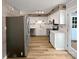 Modern kitchen featuring stainless steel appliances, white cabinetry, and stone countertops at 1908 Harvest Ln # 5, Charlotte, NC 28210